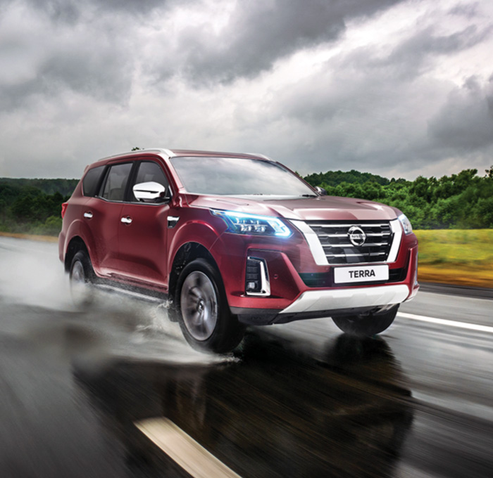 Nissan Terra driving on wet tar road